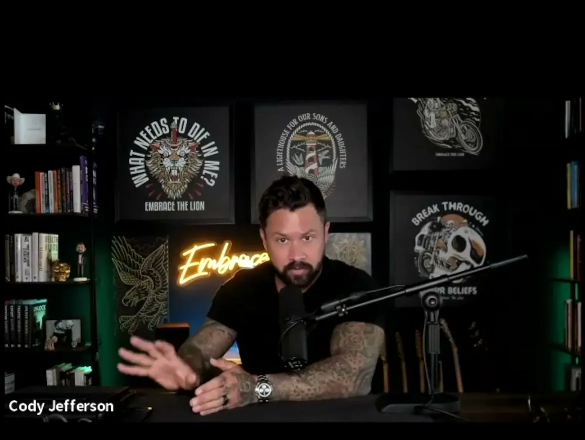 Cody Jefferson speaking at his desk in the Embrace the Lion studio