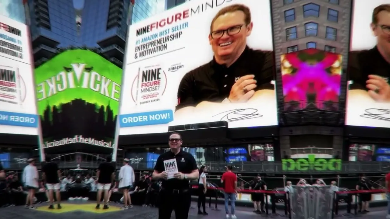 Brandon Dawson standing in Times Square, shown on surrounding billboards promoting Nine Figure Mindset